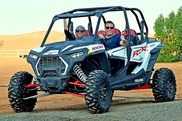 Experience the exhilaration of dune bashing in Dubai's desert mastering the sandy terrain while riding in a powerful buggy ensuring an unforgettable adventure in the Arabian landscape.